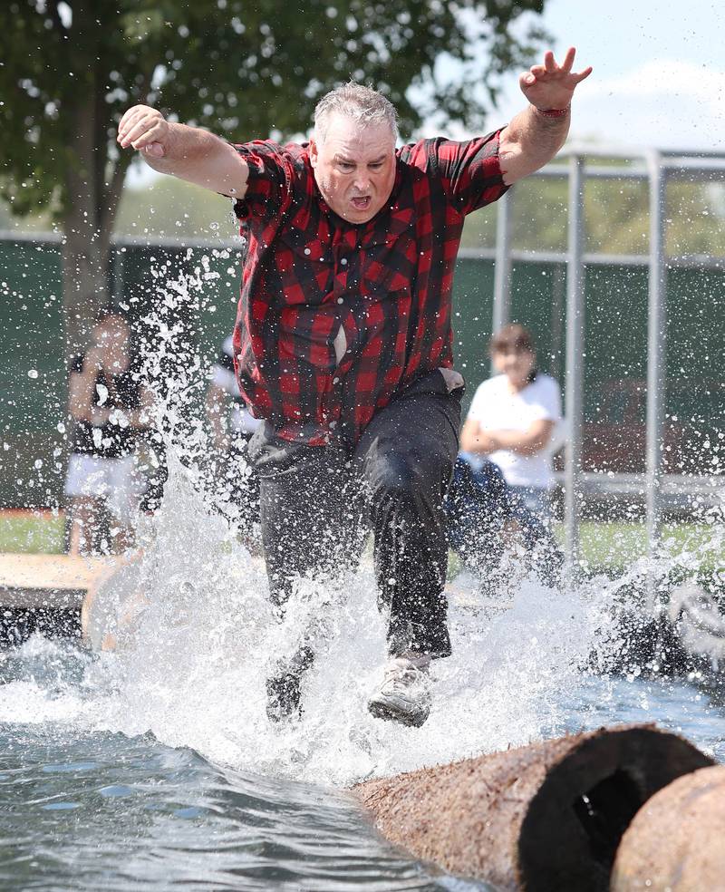 Travis Wells from Lumberjack Enterprises out of Minnesota competes in the  log running portion of the Lumberjack contest Wednesday, Sept. 7, 2022, on opening day of the Sandwich Fair. The fair continues this week through Sunday.
