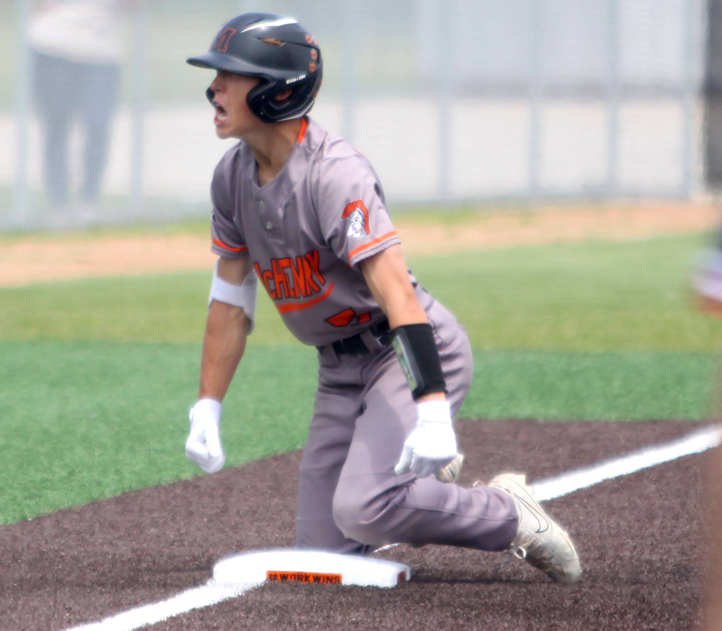 McHenry’s Landon Clements celebrates arriving safely at third base as the Warriors rally against Barrington in IHSA Class 4A Sectional Title Game baseball action at McHenry High School in McHenry on Saturday, June 7, 2025.