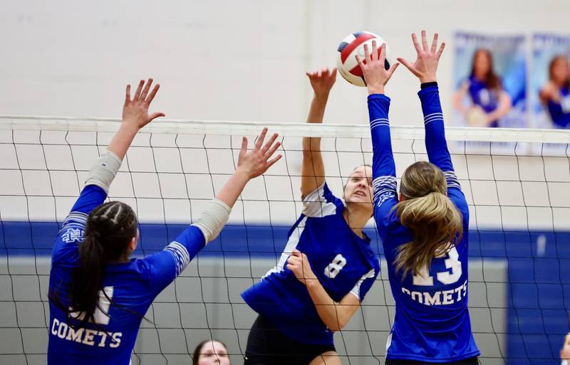 Princeton's Keighley Davis takes a hit over Sterling Newman's Kennedi Shippert in Thursday's regional finals at Prouty Gym.