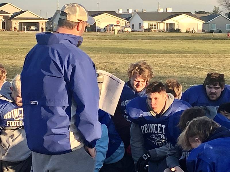 PHS senior Gabe Glass (front) listens to coach Ryan Pearson instructions at the end of Tuesday's practice at Little Siberia. Glass came out for football for the first tie and loving it.
