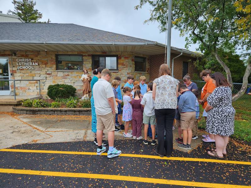 Christ Lutheran School students and teachers meet to pray at the flagpole at the Sterling school Sept. 27.