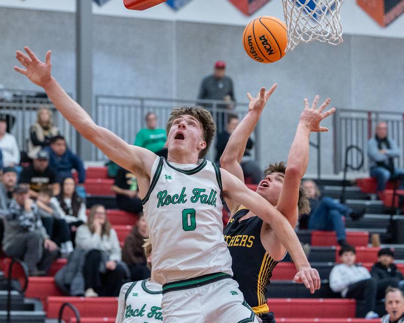 Max Burns (0) of Rock Falls fails to block shot of Johnathan Stunkel (3) of Putnam County as he goes up for a layup during the Colmone Classic on Monday, December 8, 2025 at Hall High School in Spring Valley.