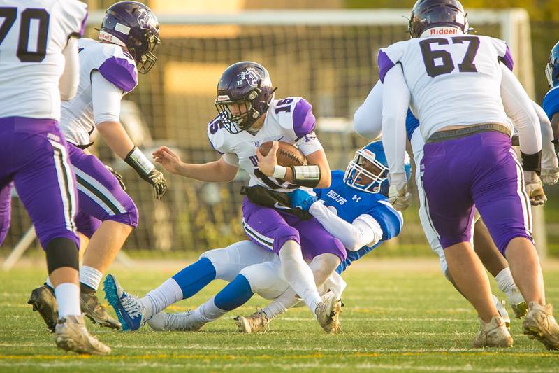 Dixon quarterback Jacob Gaither (15) is sacked by Phillips defensive lineman Renard Willis (50) in the first quarter of the football game at Gately Stadium on Saturday, Oct. 30, 2021.