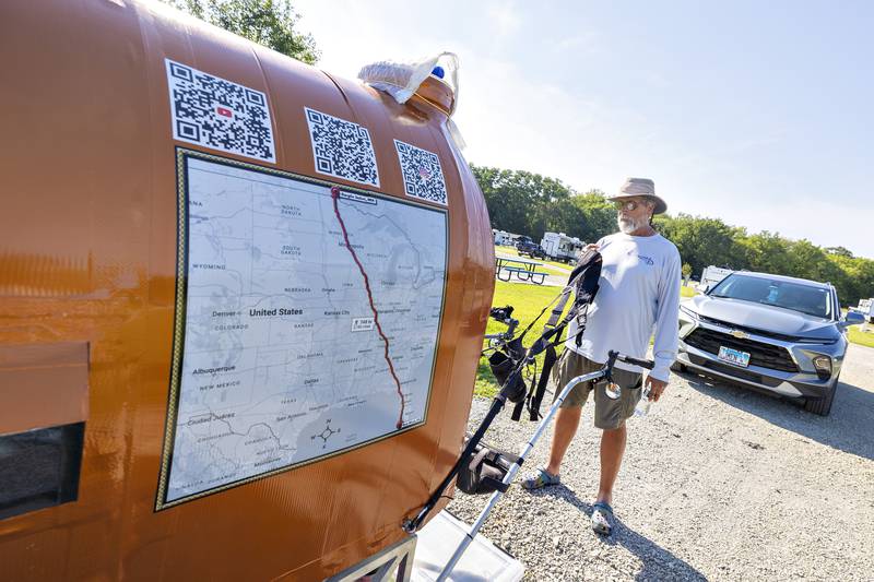 Tim Hickle shows off his self-designed wagon during a stay in Rock Falls on Friday, Aug. 15, 2025. Hickle is hiking from the northernmost part of continental America, Angle Inlet, Minnesota, to Key West, Florida.