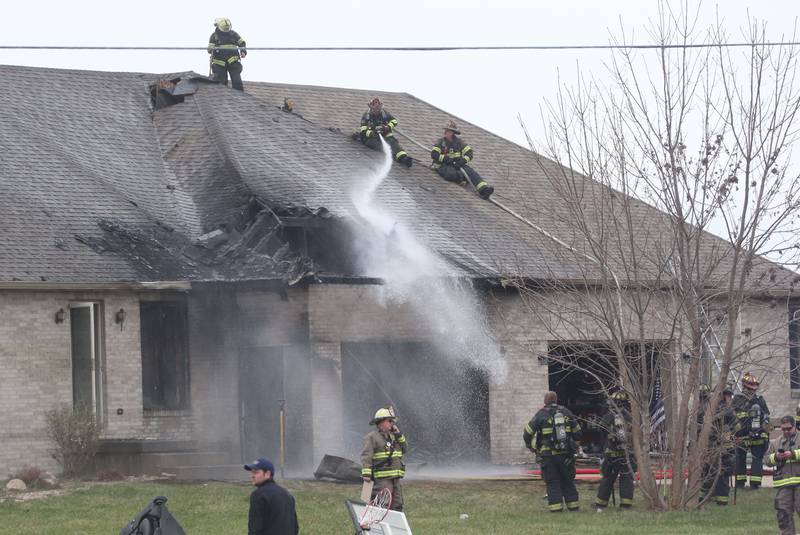 Firefighters spray water on a structure fire in the 600 block of U.S. Route 6 on Tuesday, April 1, 2025 in La Salle. Fire departments from Peru, La Salle, Utica, Troy Grove, Spring Valley, Wallace and Oglesby were dispatched just before 2:30 to a one-story dublex home.