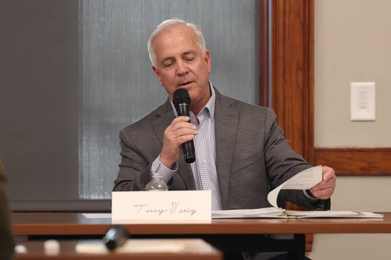 Joliet mayor candidate Terry D’Arcy looks over his binders as he answers a question at a forum for the candidates at the Joliet Public Library on Tuesday, March 28th, 2023 in Joliet.