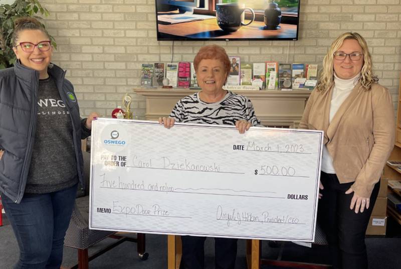 Carol Dziekanowski, center, was the winner of the $500 door prize at the Oswego Area Chamber of Commerce's Hometown Expo.  Pictured with Dziekanowski are Kelley Rice, Imagination Print & Design, vice chairman of the board and Hometown committee member, and Jodi McKinley, Old Second Bank and Hometown committee member.