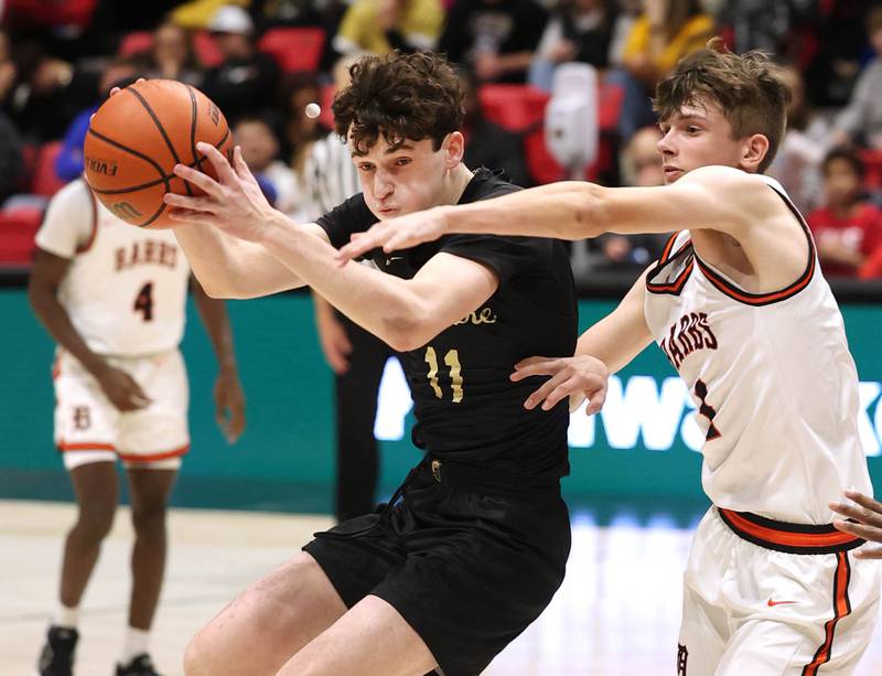 Sycamore's Jake Shipley grabs a loose ball in front of DeKalb’s Jackson Kees Friday, Jan. 26, 2024, during the FNBO Challenge in the Convocation Center at Northern Illinois University.