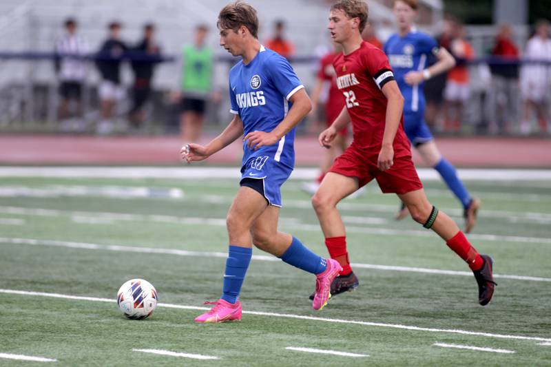 Geneva’s Peyton Friedman gets the ball away from Batavia’s Alexander Marshall during a Tri-Cities Night game at St. Charles North High School on Thursday, Sept. 21, 2023.