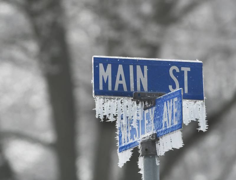 Ice and frost hang from the arm of one of the street signs in Mt. Morris on Tuesday. A wintry mix has fallen across the region the last several days including snow, sleet, freezing rain, and fog.