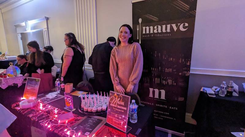 Kala Saunders, co-owner of Mauve Nosh & Libations in Shorewood, serves chocolate treats at at the Shorewood HUGS annual chocolate ball fundraiser on Saturday, Feb. 3, 2024, at the  Posh Banquets & Event Center in Joliet. The fundraiser's theme this year was "Nashville Nights."