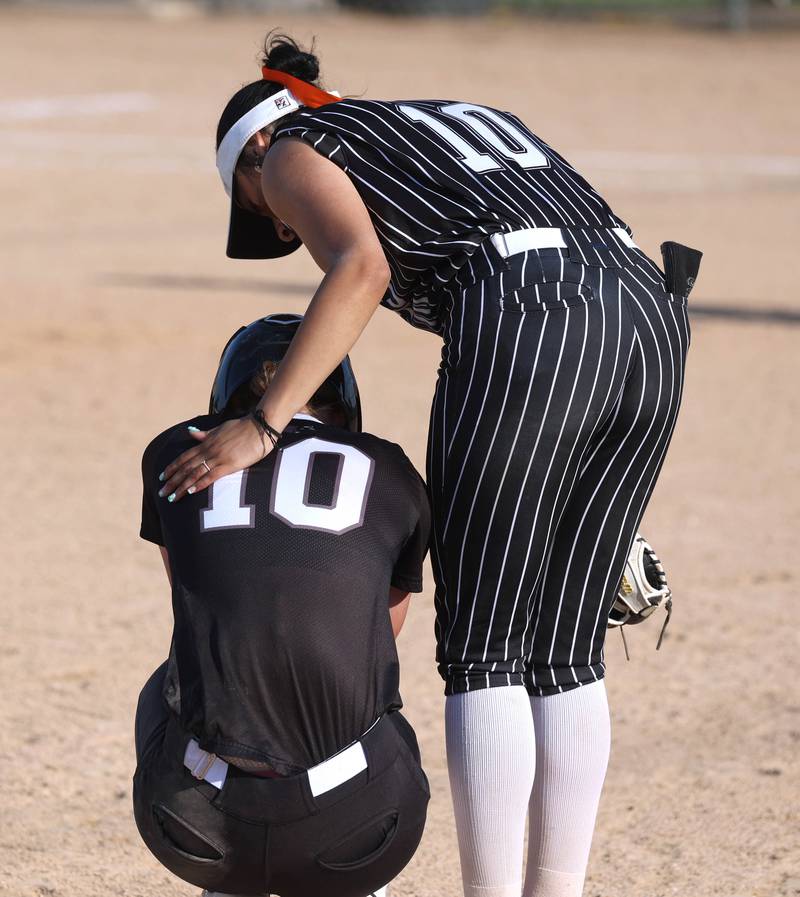 Crystal Lake Central's Liv Shaw (right) comforts an upset Prairie Ridge Kylie Carroll after a hard controversial collision on the base paths Friday, June 6, 2025, during their Class 3A sectional final game at Sycamore High School.