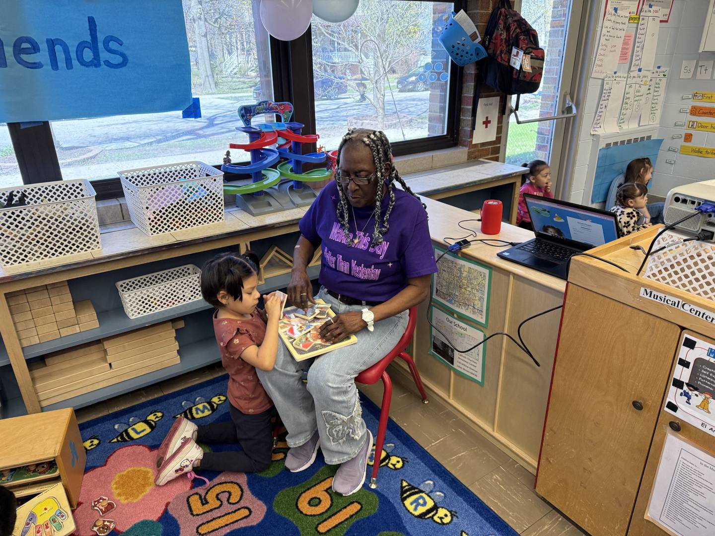 In February, Phyllis Holmes of Joliet reached 19,302 volunteer hours with the Catholic Charities, Diocese of Joliet, Foster Grandparent Program. Holmes has served in the program at the Broadway Head Start Center for 16 years and is seen with a student in April 2026.