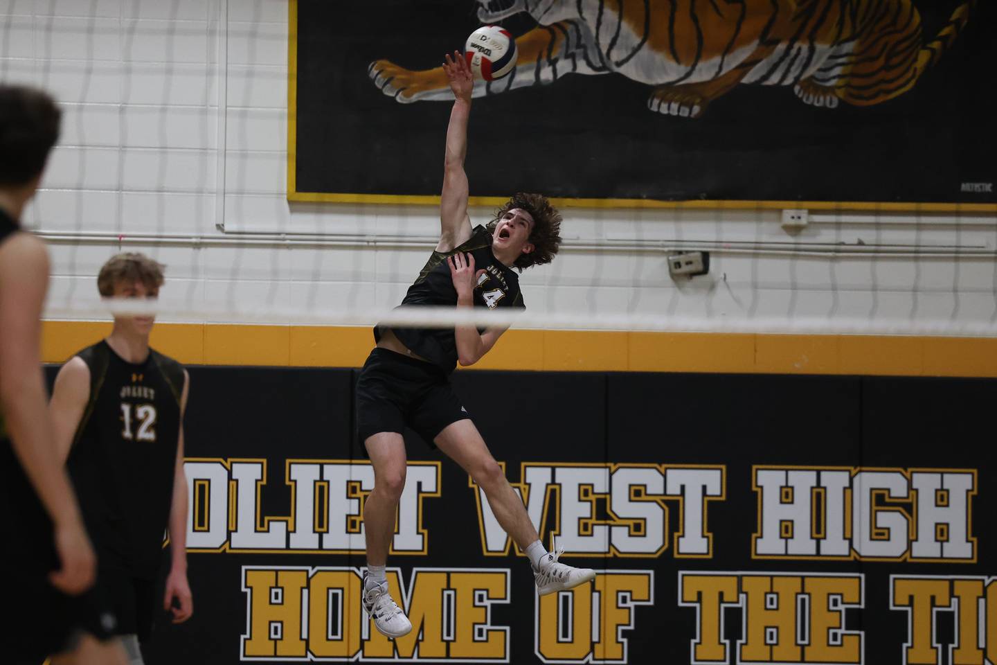 Joliet West’s Thomas Fellows serves against Providence on Thursday, March 23, 2023 in Joliet.