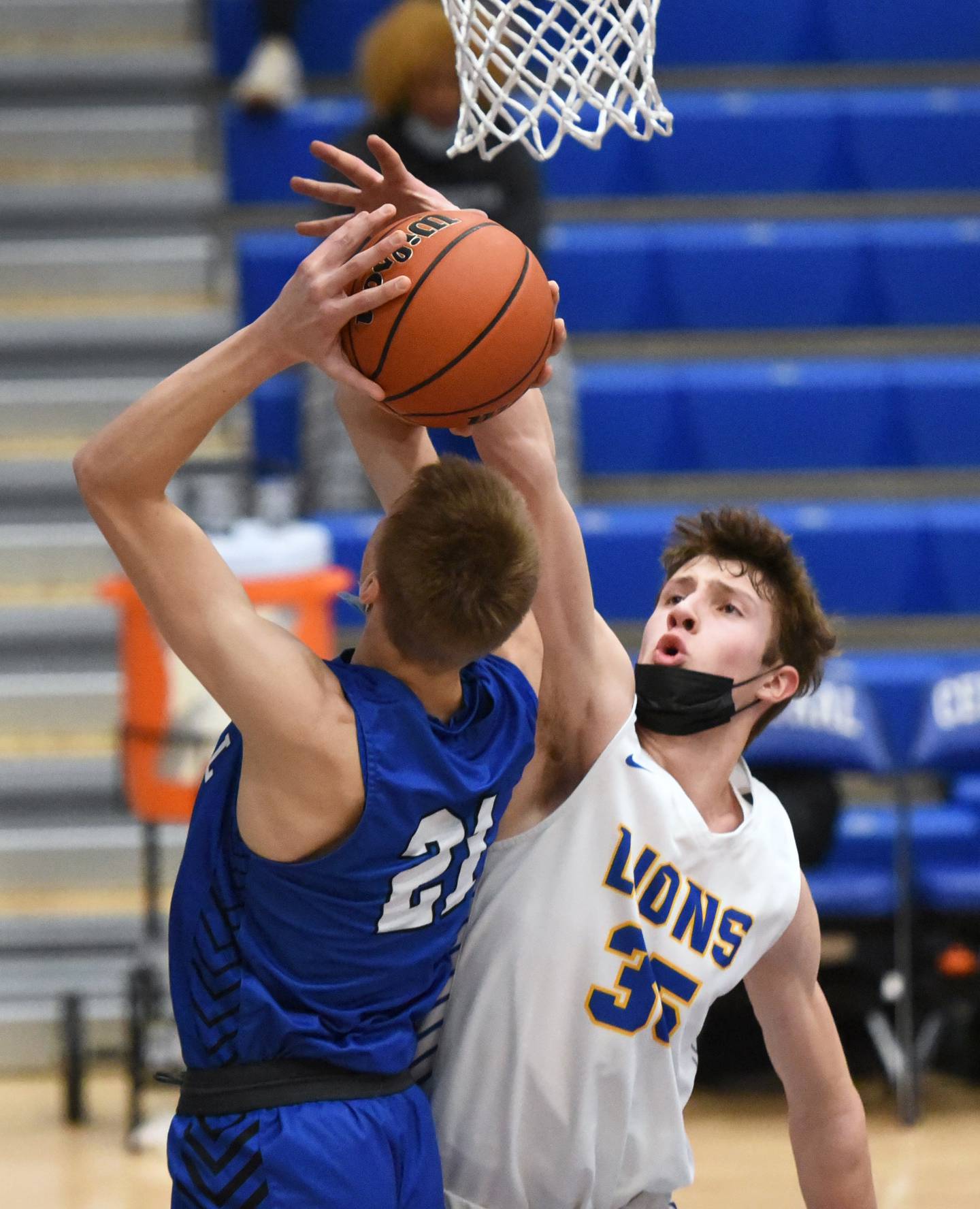 Lyons Township's Niklas Polonowski (35) tries to block of Burlington Central's Andrew Scharnowski during Monday's boys basketball game in Burlington.