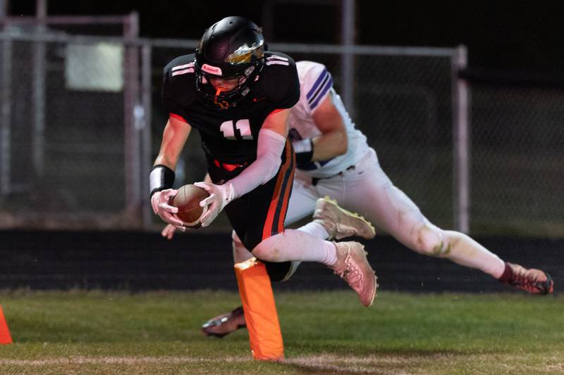 Sandwich's Nick Michalek flies into the end zone for a touchdown during Friday's game with Plano in Sandwich.