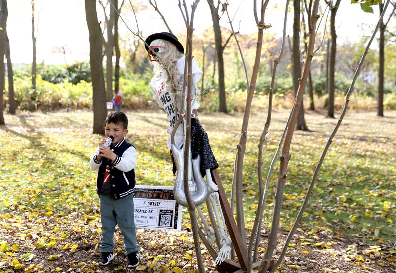 Santino Caringella, 3, of Yorkville explores the Scarecrow Walk with his mom and sister on Monday, Oct. 28, 2024 at Riverfront Park in Yorkville.