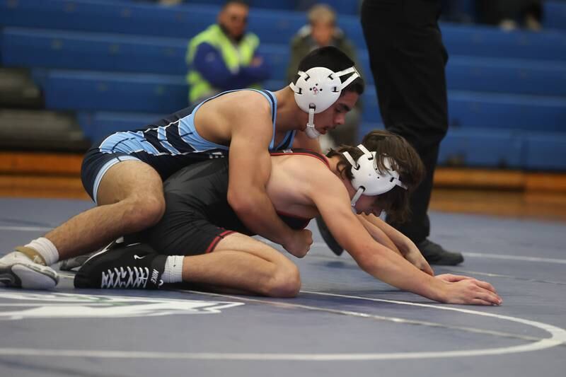 Plainfield South’s Damien Angniano works over Plainfield North’s Lucas Frydrychowski in a Southwest Prairie dual meet on Wednesday, Nov. 29, 2023 in Plainfield.