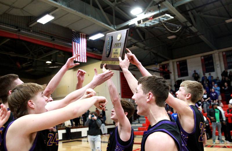 Downers Grove players celebrate their win over Bolingbrook in the Class 4A East Aurora Boys Basketball Sectional final on Friday, March 1, 2024.