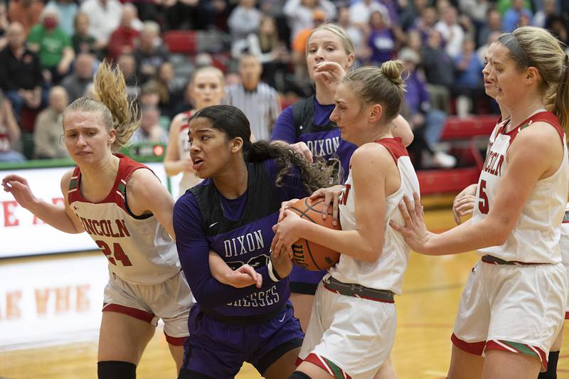 Dixon’s Ahmyrie McGowan fights Lincoln’s Becca Heitzig for the ball in the class 3A super sectional Monday, Feb. 26, 2024 at LaSalle-Peru High School.