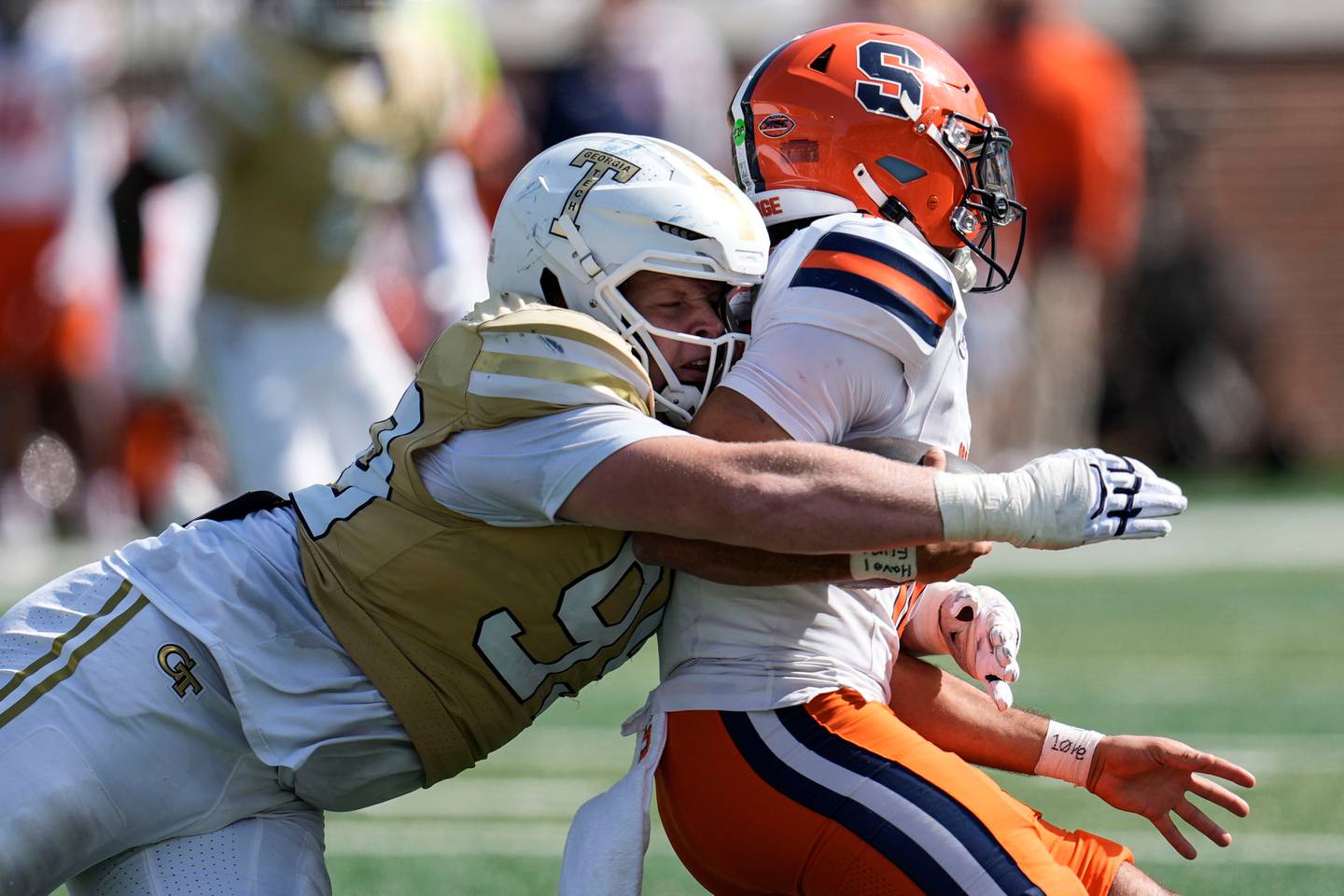 Georgia Tech defensive tackle Jordan van den Berg (99) tackles Syracuse quarterback Rickie Collins (10) during the second half of an NCAA college football game, Saturday, Oct. 25, 2025, in Atlanta. (AP Photo/Mike Stewart)