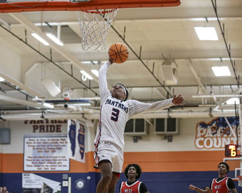 Oswego's Ethan Vahl (3) dunks during their basketball game between West Aurora at Oswego Monday, Nov 24, 2025 in Oswego.