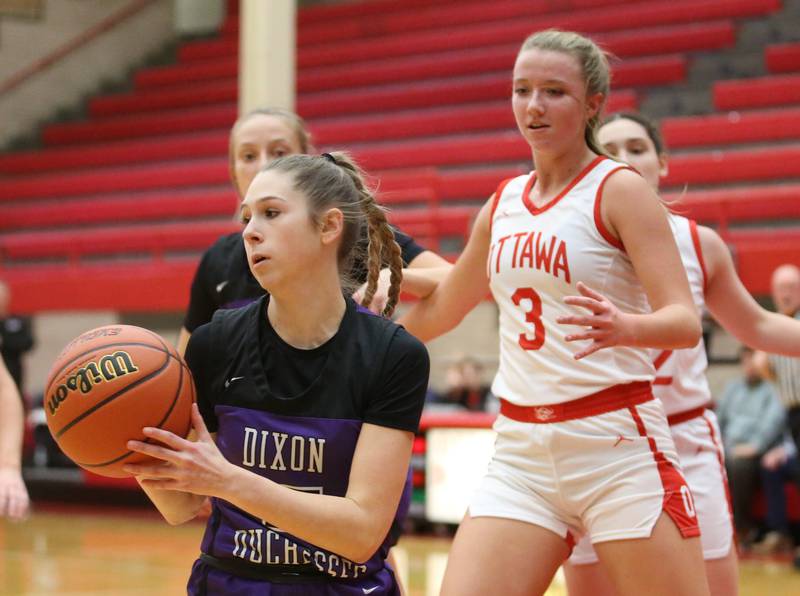 Dixon's Morgan Hargrave looks to pass the ball while Ottawa's Skyler Dorsey defends on Wednesday, Nov. 29, 2023 at Kingman Gym.