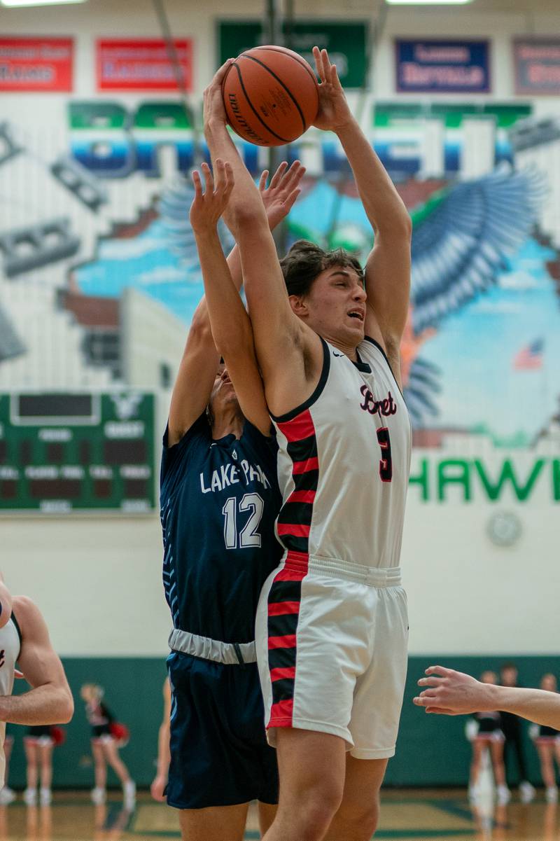 Benet’s Sam Driscoll (1) rebounds the ball against Lake Park's Joshua Gerber (12) during a Bartlett 4A Sectional semifinal boys basketball game at Bartlett High School on Tuesday, Feb 28, 2023.