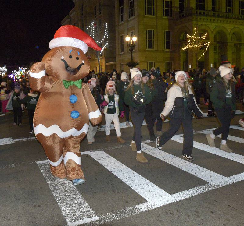 An inflatable Gingerbread Man joins the parade marching down La Salle St in Ottawa Friday during the Festival of Lights Parade.