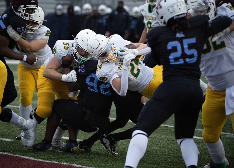 Providence Catholic's Broden Mackert, center, carries the ball into the endzone for a touchdown in the first half of a Class 5A playoff game against Kankakee on Saturday, November 8, 2025.