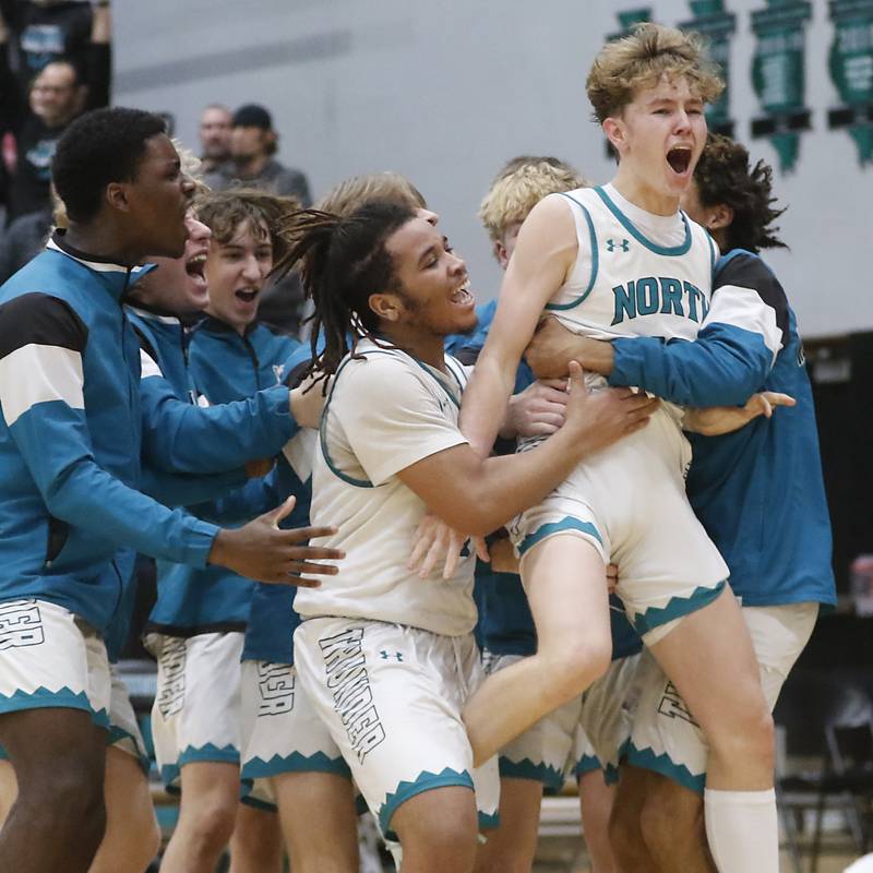Woodstock North's Trevor Mark is mugged by his teammates as they celebrate their win over Woodstock during a Kishwaukee River Conference boys basketball game on Friday, Jan. 5. 2024, at Woodstock North High School.