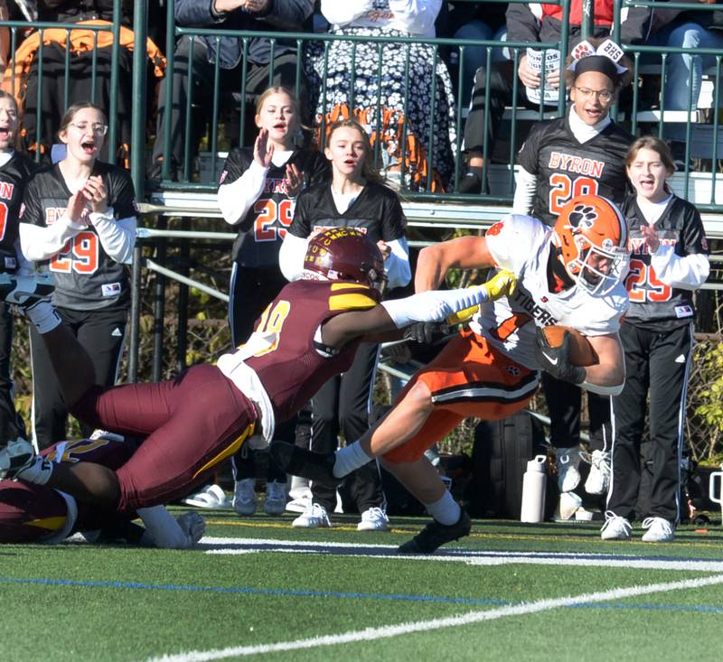 Byron's Brayden Knoll (1) fights for yards against Lombard-Montini  in 3A football semifinal action in Lombard on Saturday, Nov. 18, 2023.