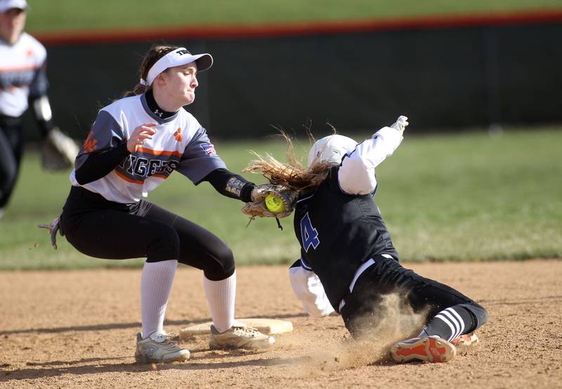 Wheaton Warrenville South’s Emma Schusler (left) tags St. Charles North’s Julia Larson out at second base during a game at Wheaton Warrenville South on Thursday, April 14, 2022.