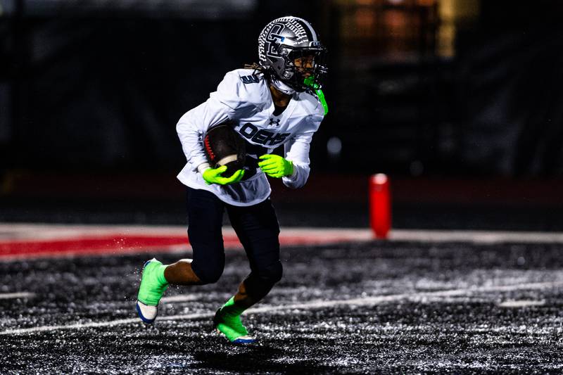 Oswego East's Zamsrion Taylor returns a punt during a game against Bolingbrook on Friday Oct. 31, 2025 at Bolingbrook High School