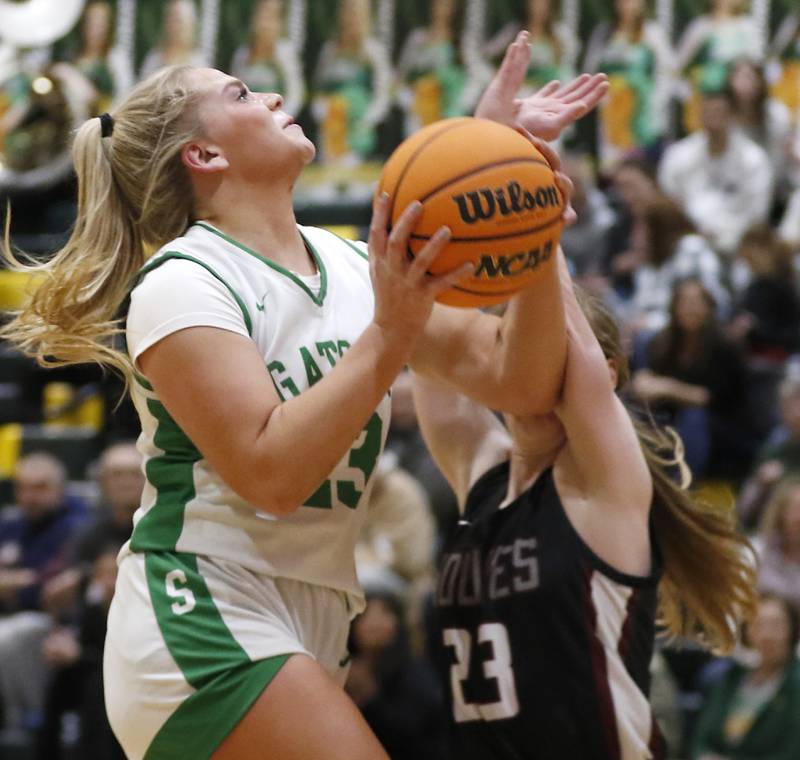 Crystal Lake South's Laken Lepage is fouled by Prairie Ridge's Bella Militello as she drives to the basket during a Fox Valley Conference girls basketball game on Friday, Dec. 13, 2024, at Crystal Lake South High School.