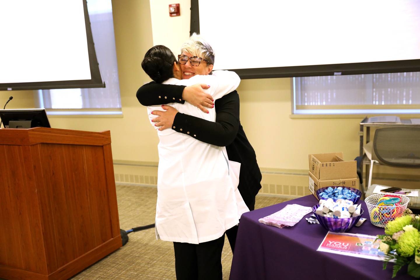 Letty Kelley (left), a registered nurse, gets a hug from Rosemarie Nolazco, critical care and emergency department director, during National Nurses Week festivities at Northwestern Medicine Delnor Hospital in Geneva on Wednesday, May 10, 2023.