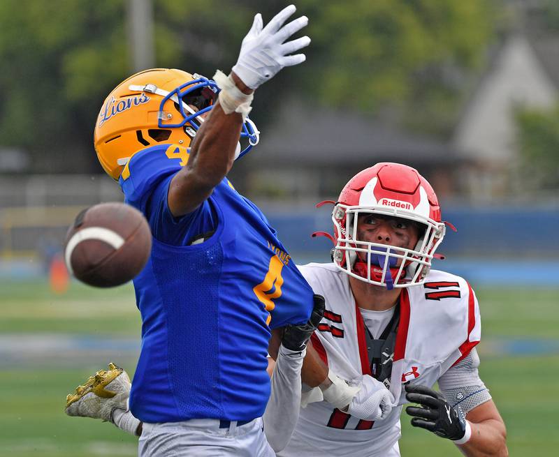 Lyons Township’s Anthony Pearson can’t reach a pass in the end zone as Hinsdale Central’s Benjamin Munoz (11) grabs his jersey during a game on September 20, 2025 at Lyons Township High School in LaGrange.