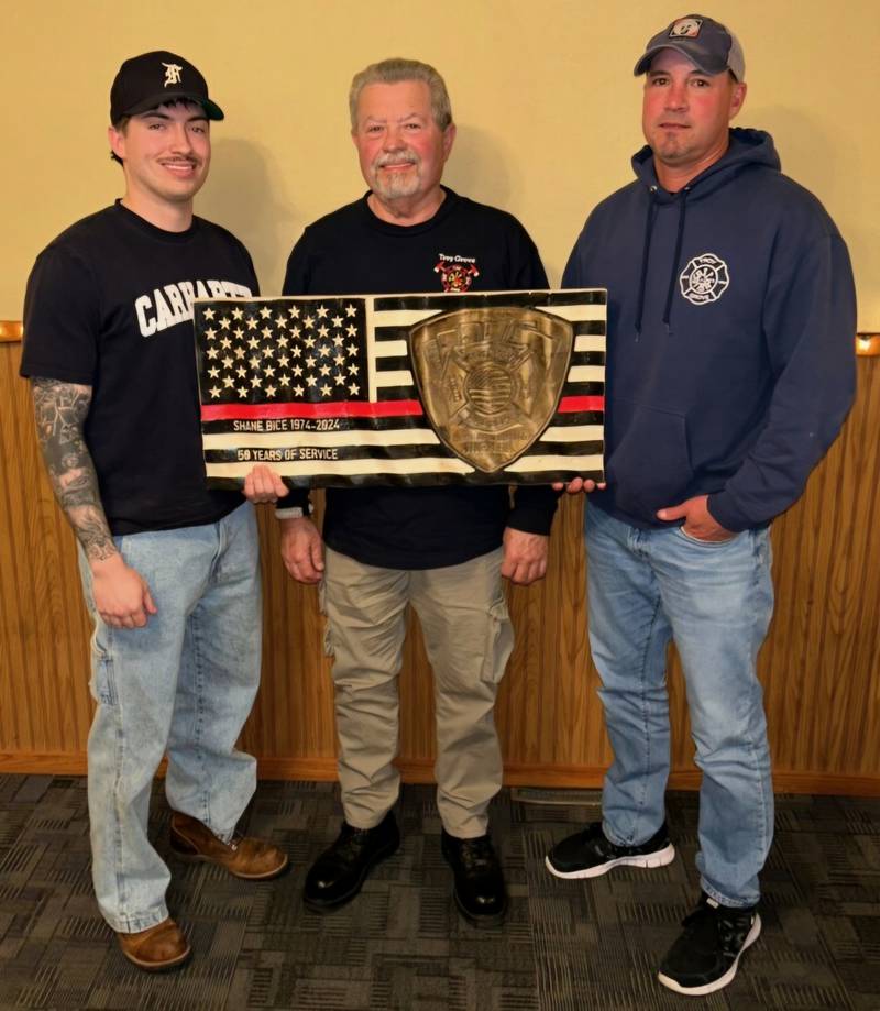 Shane Bice (center) was recently congratulated on his retirement after 50 years with the Troy Grove Volunteer Fire Department. Pictured with him are (right) his son, Troy Grove Fire Department Captain Brian Bice, who has 28 years with the department, and (left) his grandson, Brandon Bice, who has five years with Troy Grove and is now a paid firefighter with the Ottawa Fire Department.
Also honored for years of service were Chief Henry Kibilka III (46 years), Phil Brester (31), Galen Eich (31), Lt. Paul Kenny (25), Mitch Melau (22), Jason Mahaffey (21), Lt. Mike Mathieu (20), Mike Wujek (20) and Morgan Carlson, Mike Hince and Todd Zimmerlein (each 5 years).