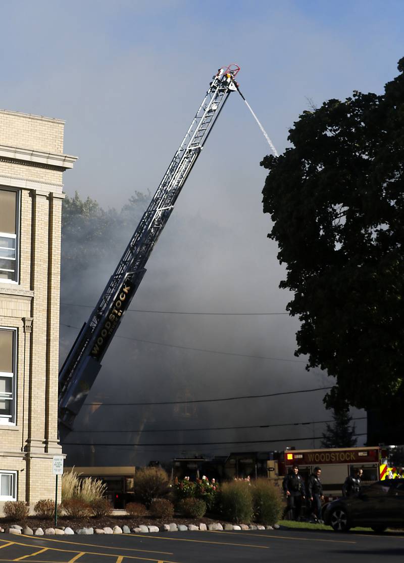 Firefighters battle a house fire in the 300 block of Lincoln Avenue in Woodstock Monday, Oct. 9, 2023, after an explosion following suspected gas leak in the area.