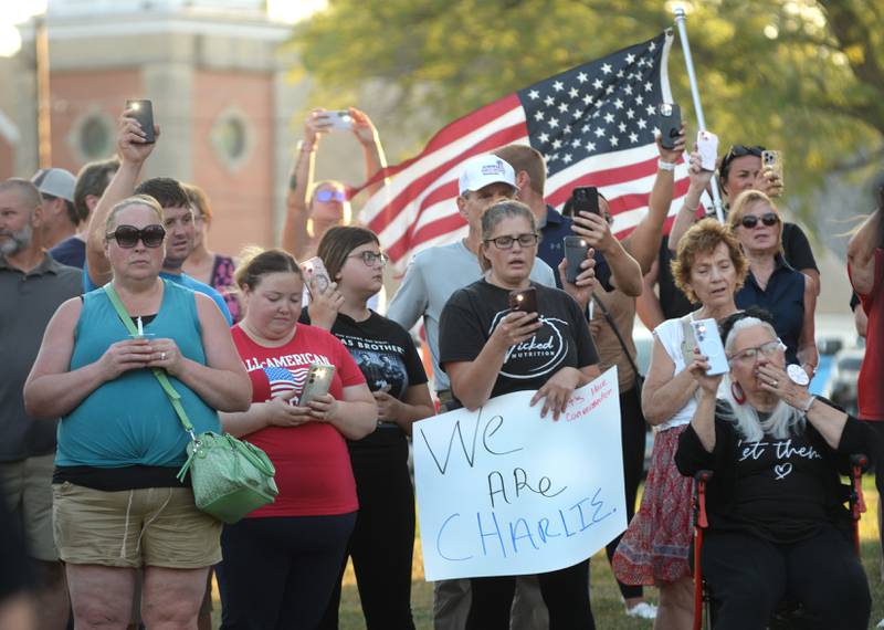 People hold their candles or cell phone  lights during a vigil for Charlie Kirk on Sunday, Sept. 14, 2025 on the Ogle County Courthouse Square in Oregon. An estimated crowd of 300-350 attended the hour-long evening event.