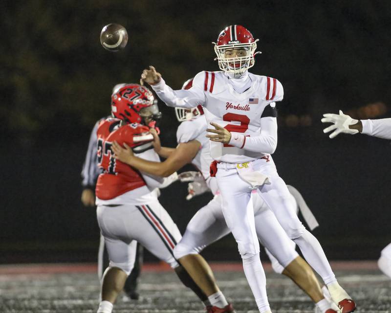 Yorkville's Jack Beetham (2) throws a pass across the middle during football game between Yorkville at Bolingbrook Friday, Oct 24, 2025 in Bolingbrook.