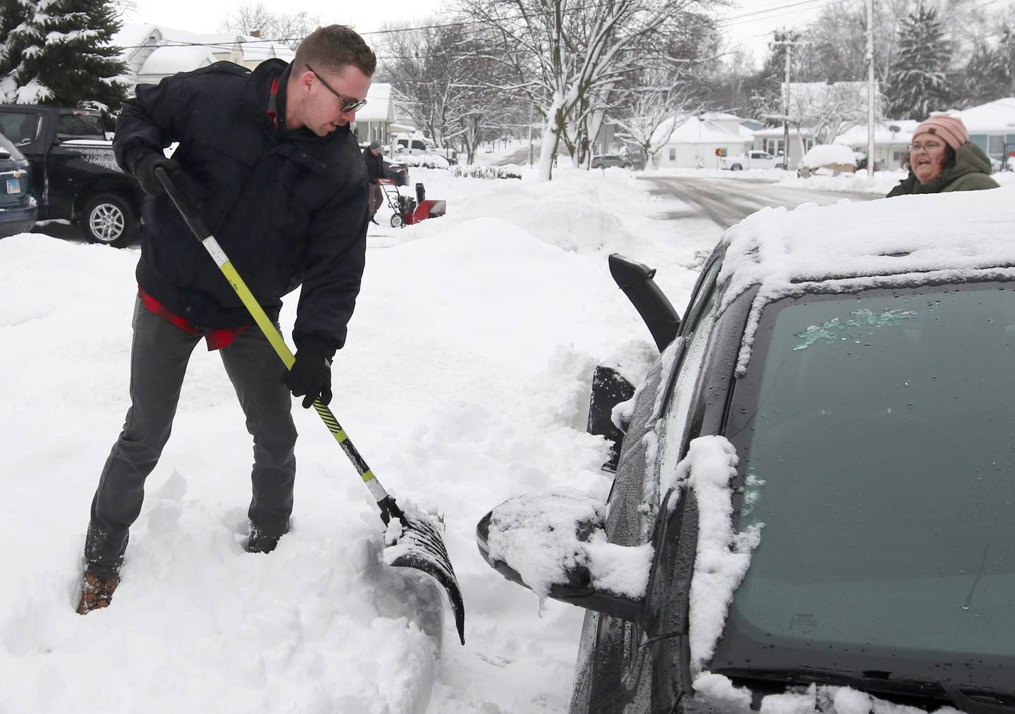 Dylan Cranden, from DeKalb, digs his car out Friday, Jan. 12, 2024, after early morning snow covered his vehicle. Several inches of snow blanketed DeKalb County Friday on top of the 6 inches that fell on the area earlier this week.