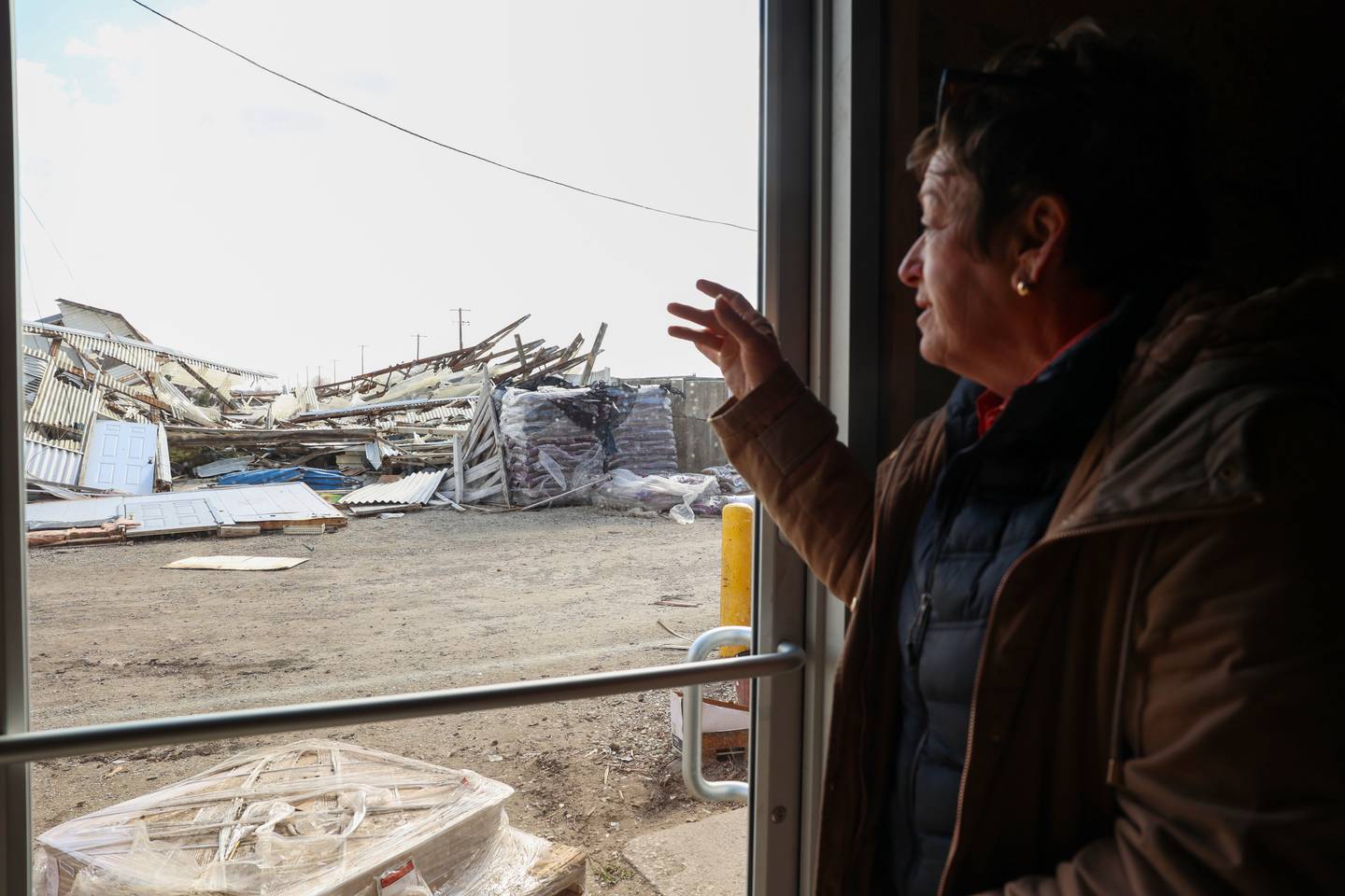 Nancy Tholen recounts the mostly stocked enclosure that now lays demolished at Tholens' Landscape & Garden Center along South Schuyler Avenue in Kankakee on March 13, 2026, following the March 10 tornado that caused widespread destruction in Kankakee County.