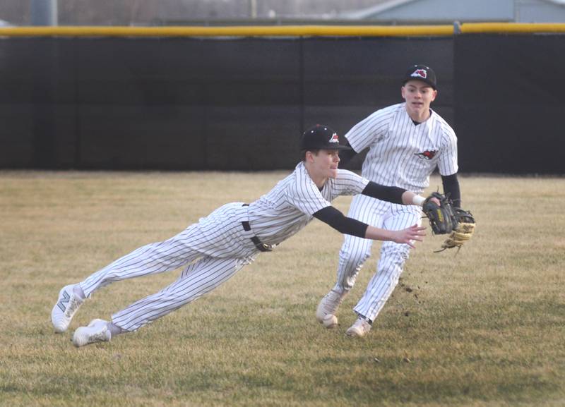 Fulton's Caden Wilkin dives for a line drive as right fielder Evan Folk backs up the play during a game with Morrison on Friday, March 21, 2025 in Fulton.