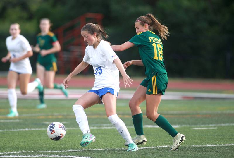 St. Charles North’s Kaitlin Glenn (left) and Fremd’s Natalia Wala go after the ball during the Class 3A state semifinal game at North Central College in Naperville on Friday, May 31, 2024.