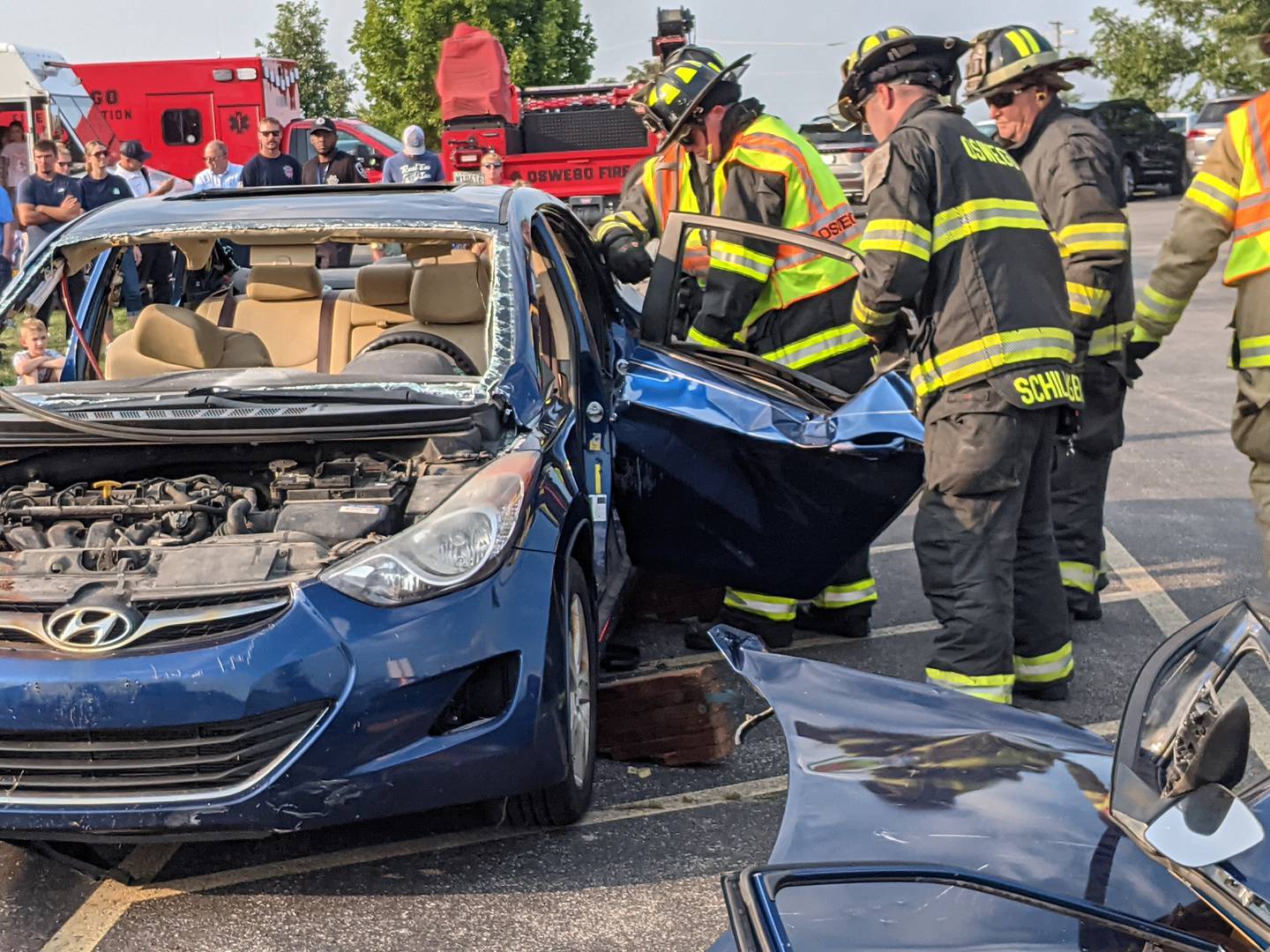 Firefighters with the Oswego Fire Protection District participate in a vehicle extrication demonstration during National Night Out on Aug. 5 at the Prairie Point Community Park in Oswego.