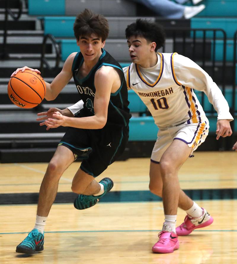 Woodstock North's Zaiden Vess drives the baseline as his defended by Hononegah's Cole Warren during the 2025 Hoops for Healing tournament basketball game on Wednesday, Nov. 26, 2025, at Woodstock North High School.