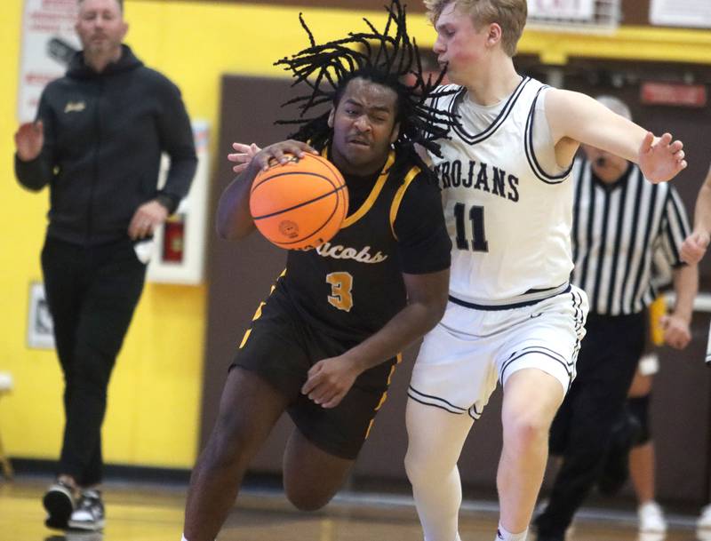 Jacobs’ Emaan Thomas, left, moves the ball against Cary-Grove’s Landon Nawracaj during Hinkle Holiday Classic varsity boys basketball tournament action on Thursday, Dec. 26, 2024 at Jacobs High School in Algonquin.