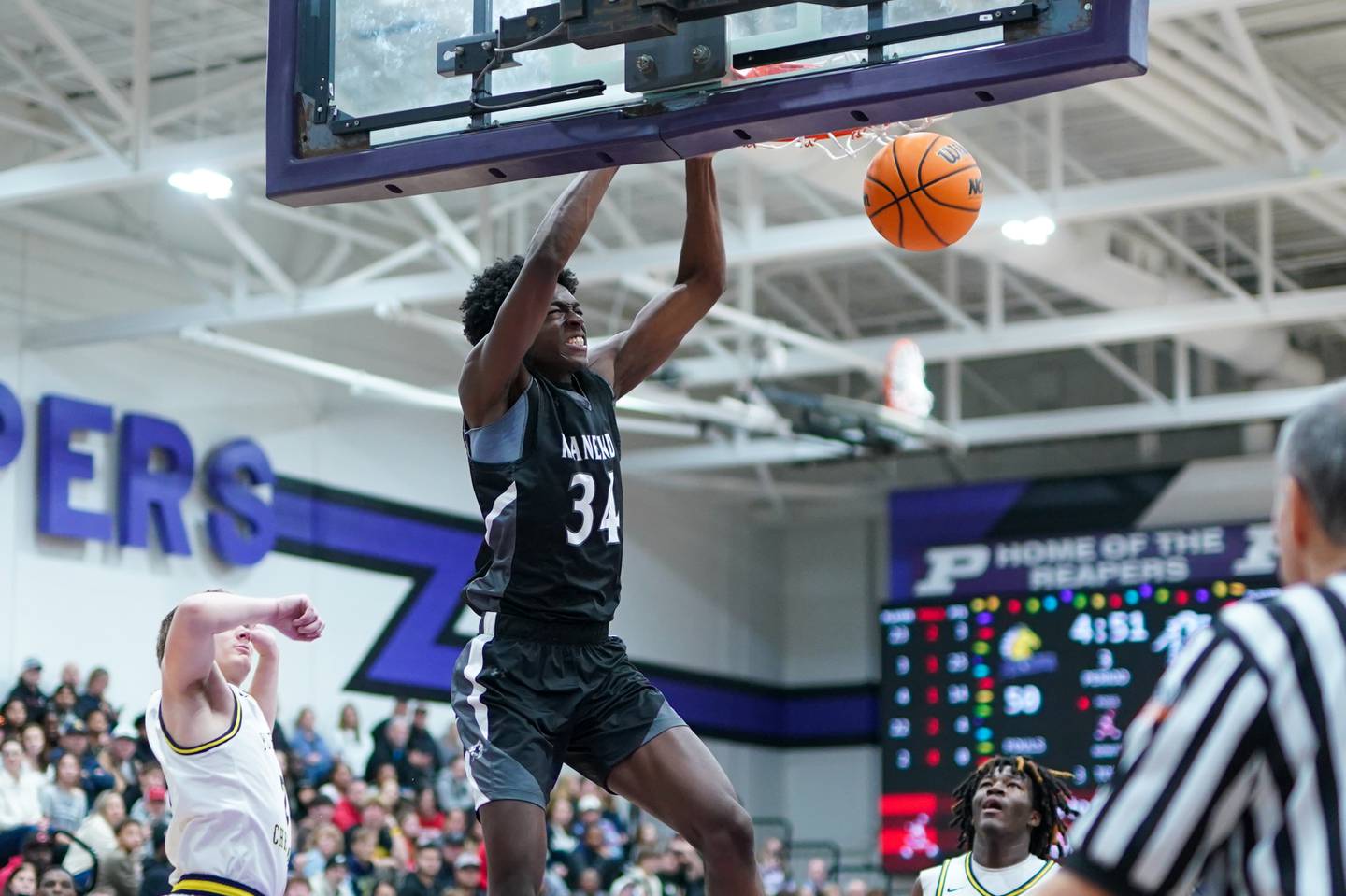 Kaneland’s Jeffrey Hassan (34) dunks the ball against Yorkville Christian during a championship final basketball game in the 61st annual Plano Christmas Classic at Plano High School on Saturday, December 28, 2024.