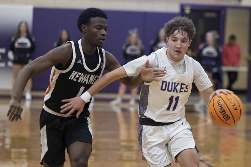 Dixon’s Brody Nicklaus handles the ball against Kewanee’s Dayvon Robinson Tuesday, Dec. 2, 2025.